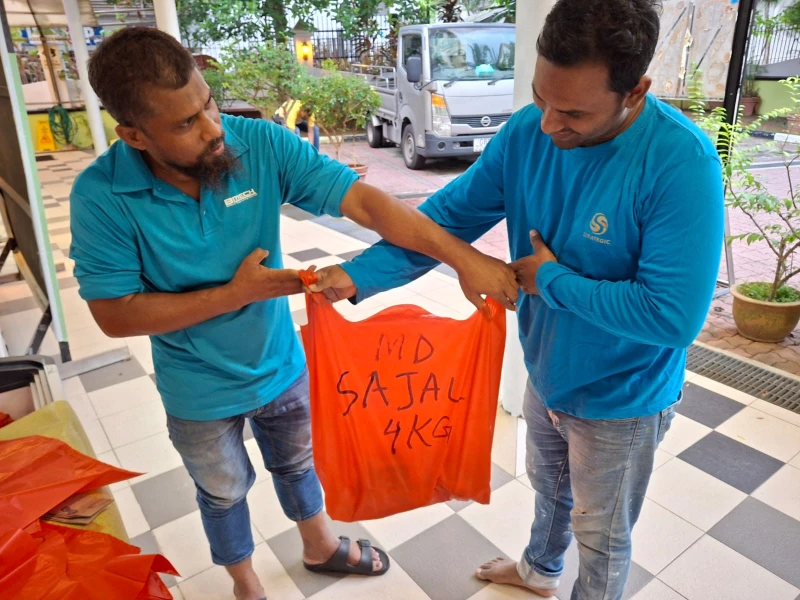 Volunteers handling labelled Qurban meat bags